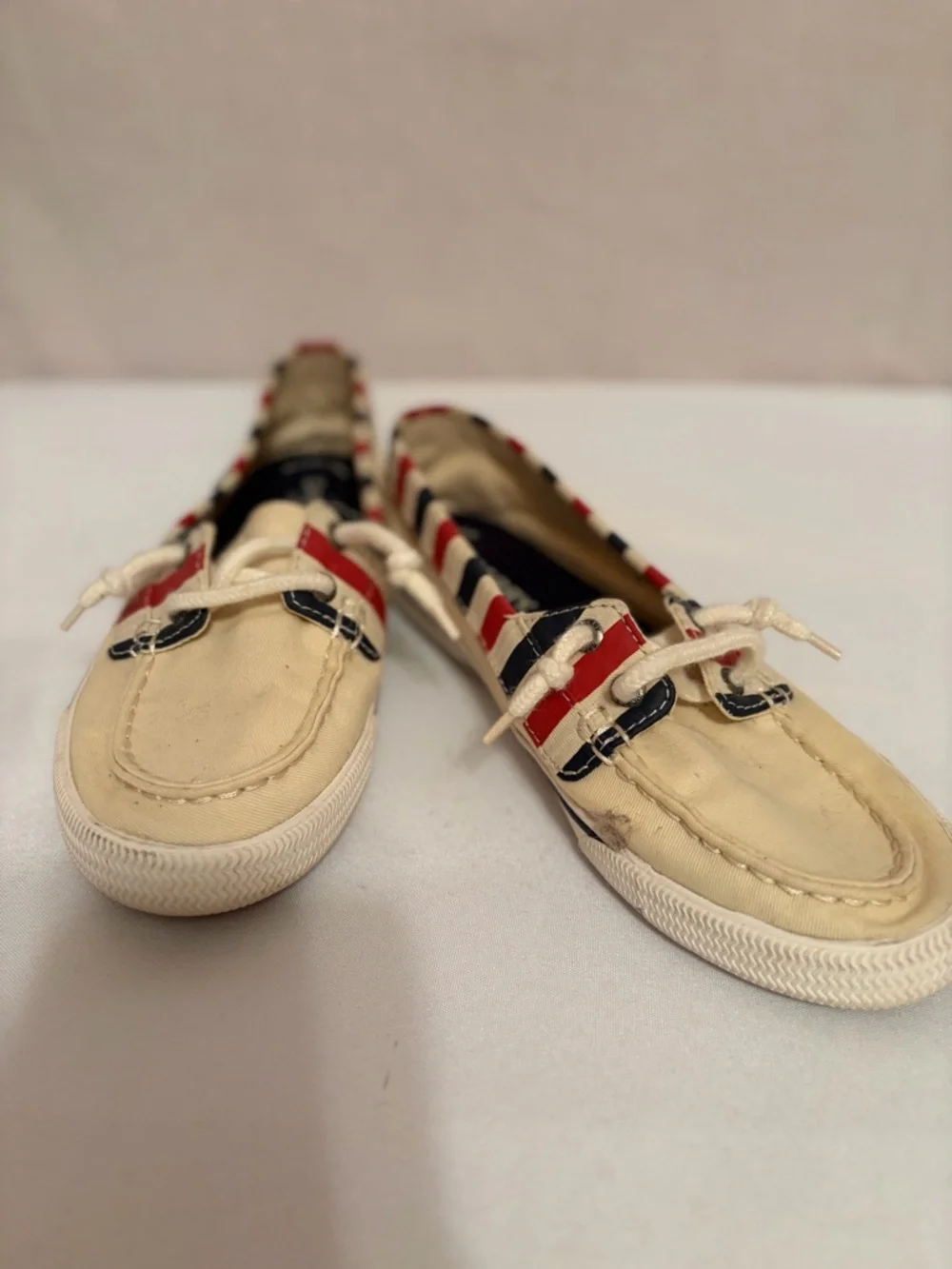 Sperry Lounge Away sneakers in a natural, red, and blue stripes